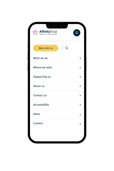A phone showing the Affinity Trust mobile navigation menu, with links to What we do, Where we work, Supporting us, and other site sections.