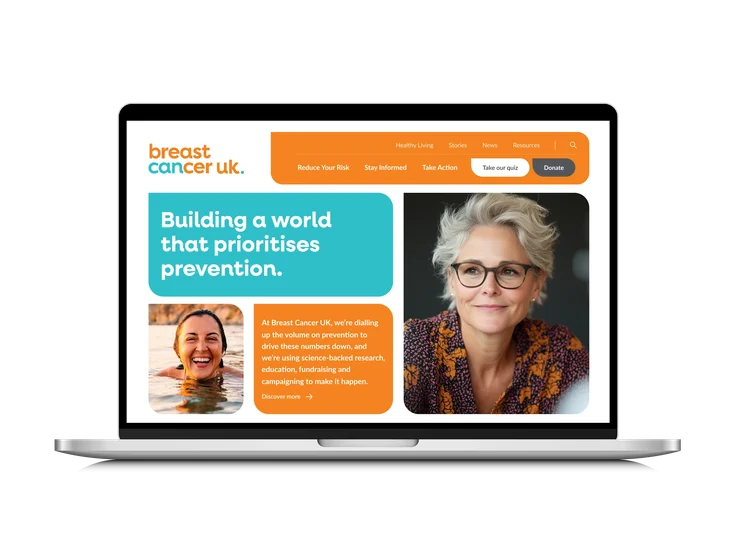 A laptop displaying Breast Cancer UK’s Desktop homepage: "Building a world that prioritises prevention" headline, navigation with Take our quiz and Donate, and two portrait photos.