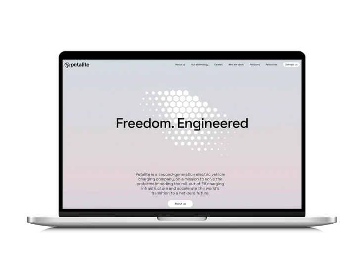 Petalite website homepage on a laptop screen, showing the headline 'Freedom. Engineered' over a hexagon graphic, with navigation for About us, Our technology, Careers, Who we serve, Products, and Resources.