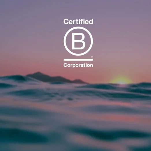 Certified B Corporation logo over a photo of the sea at sunset.