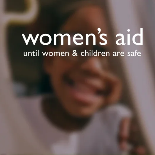 Women's Aid logo ("until women & children are safe") over a photo of a child smiling.