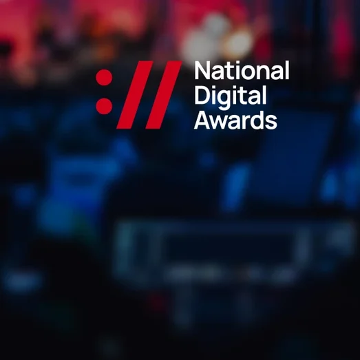 National Digital Awards logo over a blurred photo of an event stage.